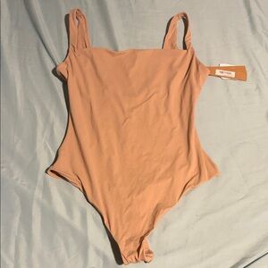 SKIMS Fits Everybody Cami Thong Bodysuit in the color Clay.